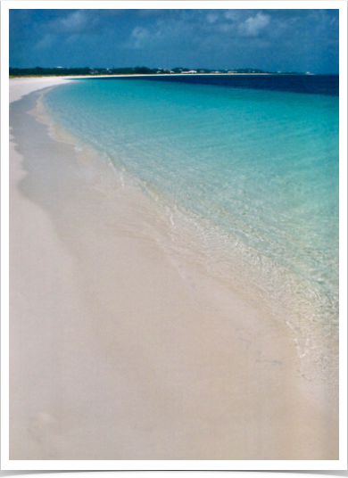 Turquoise waters and white sandy beaches of Long Bay Beach, on the southern, windward side of the island.